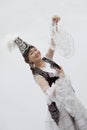 Portrait of young smiling woman dancing in traditional clothing from Kazakhstan, studio shot Royalty Free Stock Photo