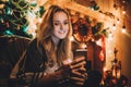 Portrait of a young smiling woman doing online shopping before christmas Royalty Free Stock Photo