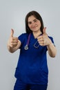 portrait of young smiling woman nurse or student in blue uniform with stethoscope isolated ob grey