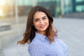 Portrait of young smiling woman outdoors with sunligth flare Royalty Free Stock Photo