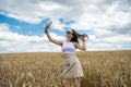 portrait of young smiling woman standing in wheat field Royalty Free Stock Photo