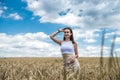 portrait of young smiling woman standing in wheat field Royalty Free Stock Photo