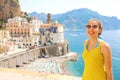 Portrait of young smiling woman with sunglasses in Atrani village, Amalfi Coast, Italy. Picture of female tourist in her summer