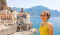 Portrait of young smiling woman with sunglasses in Atrani village, Amalfi Coast, Italy. Picture of female tourist in her summer Royalty Free Stock Photo