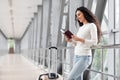 Portrait Of Young Smiling Woman Waiting For Flight In Airport Terminal, Royalty Free Stock Photo