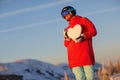 Portrait of young snowboarder girl with snow heart in hands Royalty Free Stock Photo