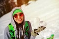 Portrait of young snowboarder girl With snow heart in hands Royalty Free Stock Photo