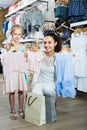 portrait of woman and girl shopping kids apparel in clothes store Royalty Free Stock Photo