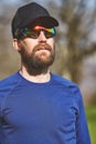 Portrait of young sporty man with beard with sunglasses