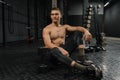 Portrait of young sporty man with bottle rest in gym after workout