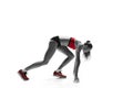 Portrait of young sporty woman at starting block of race isolated over white background Royalty Free Stock Photo