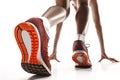 Portrait of young sporty woman at starting block of race over white background