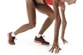 Portrait of young sporty woman at starting block of race over white background Royalty Free Stock Photo