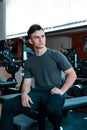 A portrait of a young strength athlete in a gym.