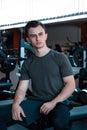 A portrait of a young strength athlete in a gym.
