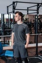 A portrait of a young strength athlete in a gym.