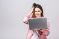 Portrait young stressed displeased worried business woman with laptop computer isolated over white background. Negative face Royalty Free Stock Photo