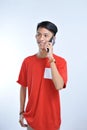 Portrait of a young student asian man talking on mobile phone, speak happy smile Royalty Free Stock Photo