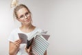 Portrait of young student girl with books isolated over grey wall background Royalty Free Stock Photo