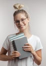 Portrait of young student girl with books isolated over grey wall background Royalty Free Stock Photo