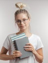 Portrait of young student girl with books isolated over grey wall background Royalty Free Stock Photo