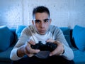 Close up portrait of young addicted man playing video game at night in gaming and addiction concept Royalty Free Stock Photo