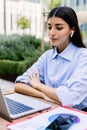 Portrait of young student woman listening on laptop video call sitting outdoors. Royalty Free Stock Photo