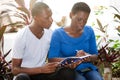 Portrait of young students sitting with notebook