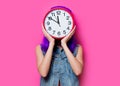 Hipster girl with purple hair and big clock Royalty Free Stock Photo