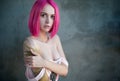 Portrait of young stylish emo girl with tattoos and pink hair Royalty Free Stock Photo