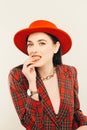 Portrait of young stylish girl. Fashion portret of elegant woman in hat and jacket. Studio shot