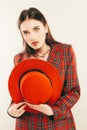 Portrait of young stylish girl. Fashion portret of elegant woman in hat and jacket. Studio shot