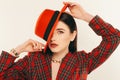 Portrait of young stylish girl. Fashion portret of elegant woman in hat and jacket. Studio shot