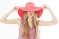 Portrait of young stylish kissing girl model in colour casual summer clothes in red pink hat with natural makeup and long blond Royalty Free Stock Photo