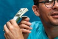 Young stylish man counting heaps of money Royalty Free Stock Photo