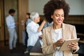 Portrait of young successful black woman working with tablet in office Royalty Free Stock Photo