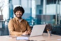 Portrait of young successful businessman inside office at workplace, hispanic smiling and looking at camera, male Royalty Free Stock Photo