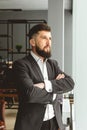 Portrait of a young successful businessman in a suit in the office. Close-up standing by the window Royalty Free Stock Photo