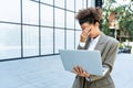 Portrait of young successful businesswoman office worker using laptop computer outside office building in formal wear. Royalty Free Stock Photo