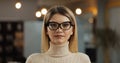 Portrait of young successful businesswoman wearing stylish glasses looking at camera standing in office workspace. Royalty Free Stock Photo