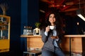 Portrait of a young successful girl, drinking coffee while working in coffee shop Royalty Free Stock Photo