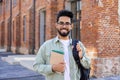 Portrait of young successful smiling student, Indian man close up smiling and looking at camera, man standing outside Royalty Free Stock Photo