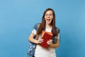 Portrait of young surprised amazed happy woman student in glasses with opened mouth with backpack holding school books Royalty Free Stock Photo