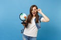 Portrait of young surprised amazed woman student with opened mouth with backpack removing glasses holding world globe Royalty Free Stock Photo