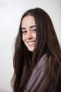 Portrait of a young and sweet natural woman without makeup with long brown hair