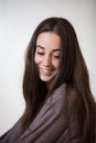 Portrait of a young and sweet natural woman without makeup with long brown hair