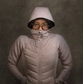 Portrait of young sweet and nerd Asian Korean teenager student woman wearing glasses and hood jacket in hipster and nerdy style Royalty Free Stock Photo