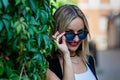 Portrait of a young, sympathetic, blonde woman in a park near the house - image Royalty Free Stock Photo