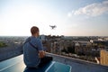 Young technician man flying UAV drone with remote control in city Royalty Free Stock Photo
