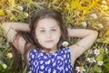 Portrait of a young teen girl happy lying in daisies Royalty Free Stock Photo